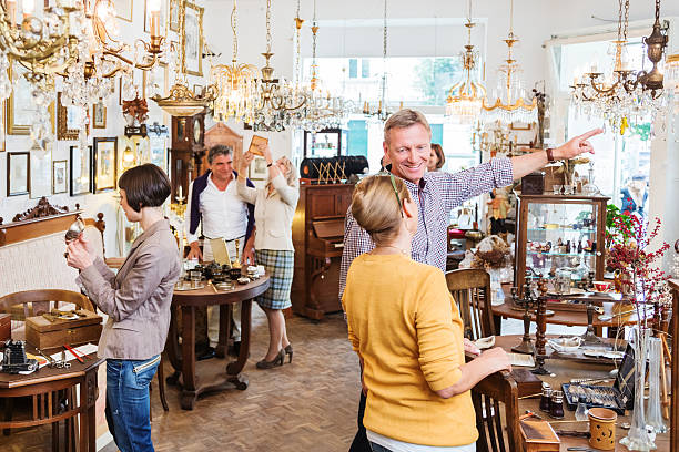 Shop owner arranging antique pieces